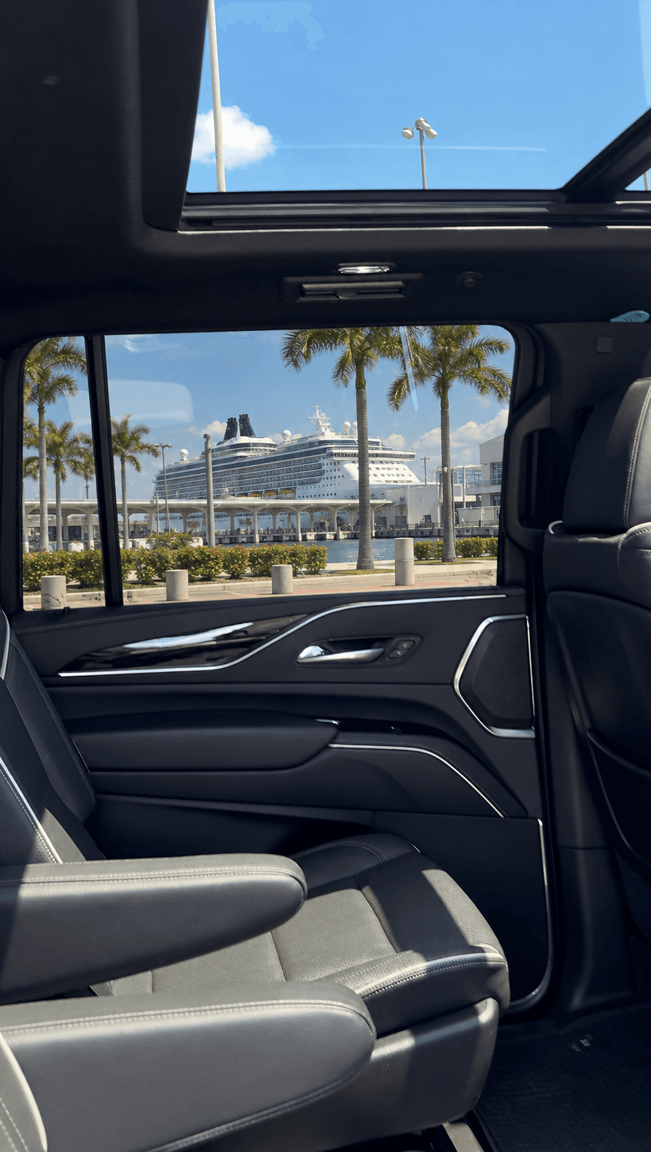 Miami Bliss chauffeur opening the door of a luxury SUV for private car service to Port Everglades